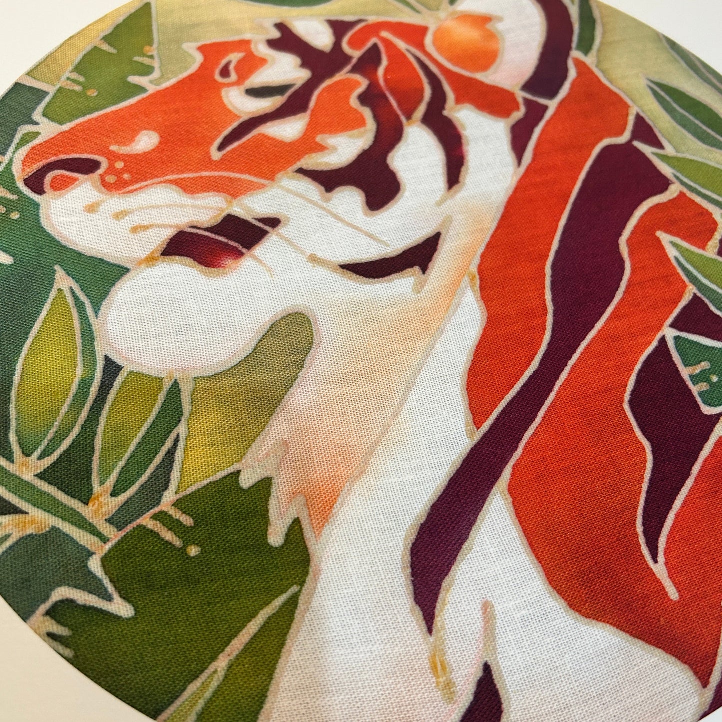 Close-up of a batik craft kit Malayan tiger design showing vibrant orange and green colours on fabric