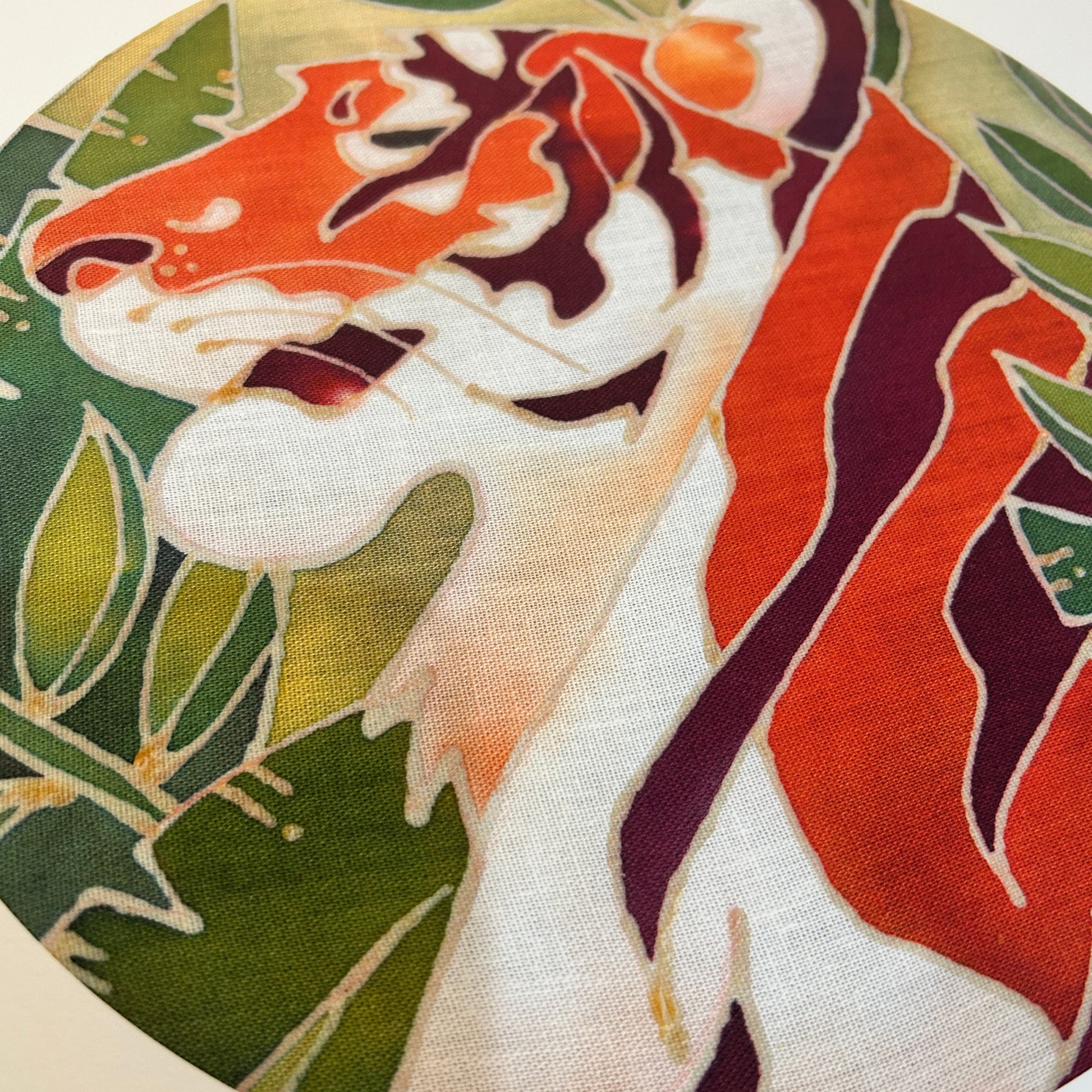 Close-up of a batik craft kit Malayan tiger design showing vibrant orange and green colours on fabric