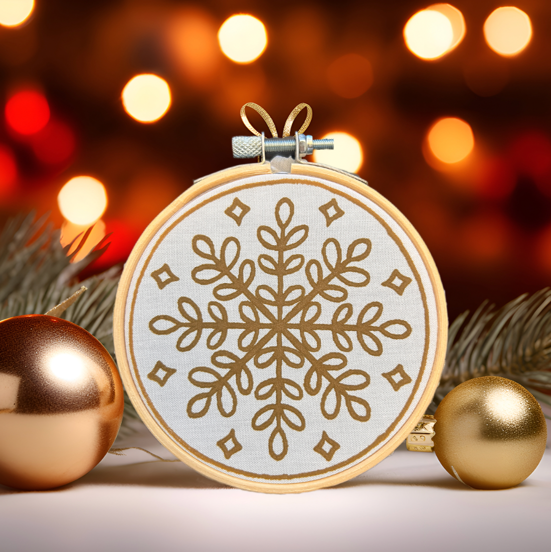 Batik Ying DIY kit featuring a mini batik snowflake ornament in embroidery hoop with festive lights background