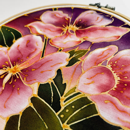 Close-up of pink floral design in Batik Ying classic batik craft kit displayed in embroidery hoop