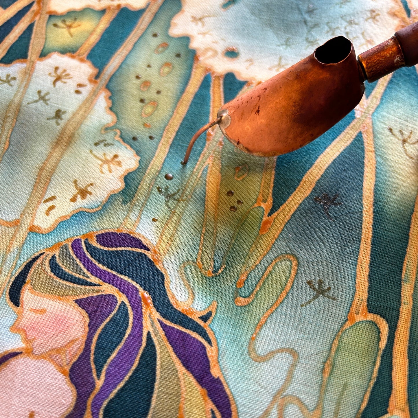 Close-up of original contemporary batik art print featuring a copper canting tool and intricate designs