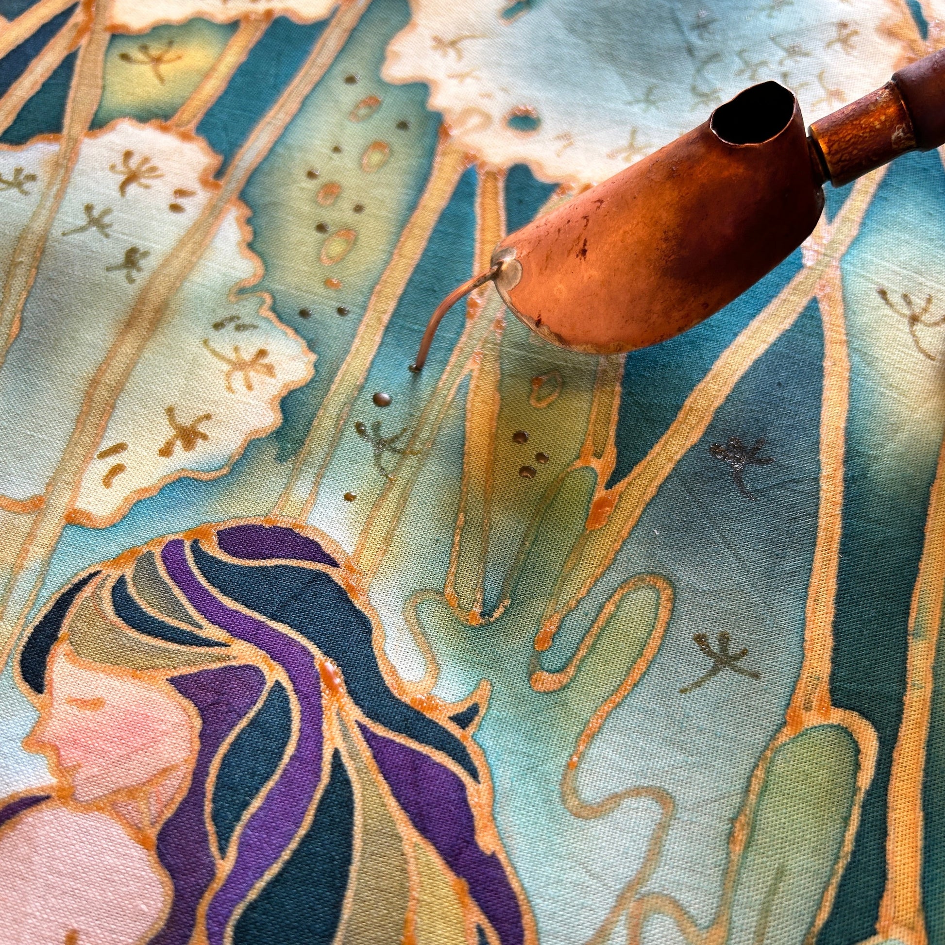 Close-up of original contemporary batik art print featuring a copper canting tool and intricate designs