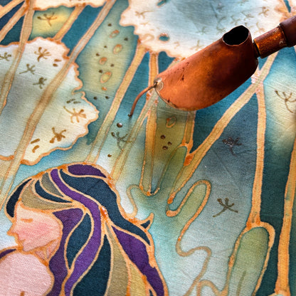 Close-up of original contemporary batik art print featuring a copper canting tool and intricate designs